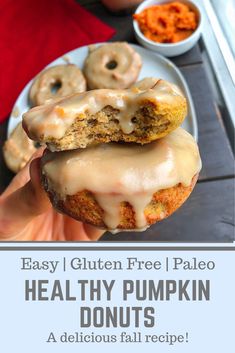 a person holding up a doughnut with icing on it and the words easy gluten free paleo heal thy pumpkin donuts