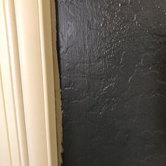 the corner of a bathroom with black walls