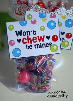 a bag filled with candy sitting on top of a table next to a sign that says won't chew be mine