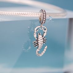 This is charm only, bracelet is sold separately. Add a striking statement to your bracelet with this one-of-a-kind scorpion sterling silver pendant charm. Crafted with solid 925 sterling silver and a platinum plating process, its highly polished finish shines brilliantly and captures attention. With intricate details, the unique scorpion insect design adds a touch of coolness and makes a perfect gift for a special someone. Materials: 925 sterling silverFinish: oxidationDimensions: 1.02 x 0.32 in Hole size: 0.18 in Jewelry Care: See more information about how to care for your jewelry here. Shipping Policy: Orders will be shipped within 1-3 business days. Economy shipping will take 7-14 days to arrive and standard shipping is 1- 4 days for U.S. orders. International shipping time is depended Sterling Silver Pendant Charm Bracelet, Sterling Silver Pendant Charm In Silver, Silver Sterling Silver Pendant Charm, Symbolic Sterling Silver Charm Bracelet, Symbolic Sterling Silver Charm Bracelet With Lobster Clasp, Silver Charms With Dangling Snake Chain, Silver Snake Chain With Dangling Charms, Silver Dangling Charms On Snake Chain, Silver Sterling Silver Charm Bracelet With Lobster Clasp