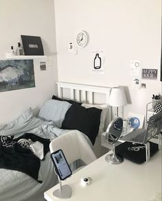 a bed room with a desk and a laptop