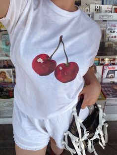 Hand-painted cherries on a lightweight 90s style baby tee. Please read the full product description below before ordering ♡ Photos & videos: @brookefarnsworth in our tee 🍒 ⋆ ˚｡ ⋆୨♡୧⋆ ˚｡ ⋆ ✩ QUALITY & SUSTAINABILITY ✩ * Quality 100% cotton tees, digitally printed with premium ink - we make our tees to last. * Every one of our tees is printed to order to reduce waste. * Our t-shirt manufacturer is certified fair trade approved - they provide living wages, source sustainably grown quality cotton a Cherry Tee Shirt, Y2k T-shirt With Cherry Print, Pink Cherry Print Graphic Tee, Trendy White T-shirt With Cherry Print, Pink Cotton T-shirt With Cherry Print, Cherry Baby, 90s Baby, Baby Tees Y2k, Y2k Baby Tee