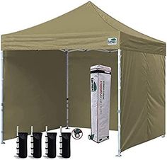 a large tent with four poles and three water bottles next to the sidewalls