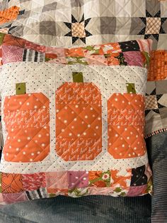 a quilted pumpkin pillow is sitting on a couch with the words happy fall written on it