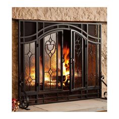 an iron fireplace screen with fire and flames