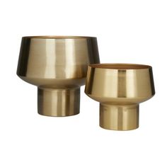 two brass cups sitting next to each other