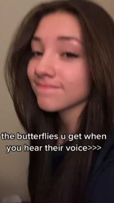 a girl with long brown hair is smiling at the camera