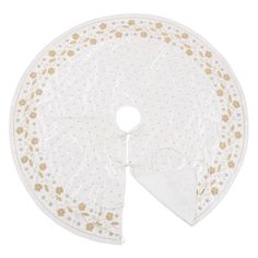 a white and gold polka dot tablecloth with a flower design on the edge, in front of a white background