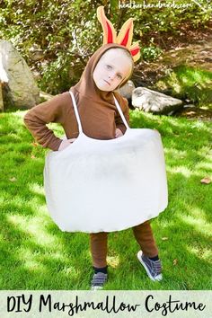 a young child wearing a costume made out of an old mattress and the words diy marshmallow costume