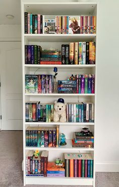 a white book shelf filled with lots of books