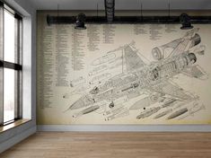 a drawing of a fighter jet on a wall in an empty room with large windows