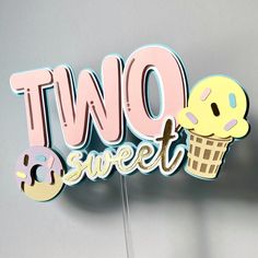 the two sweet sign is decorated with donuts and icecream on it's stand