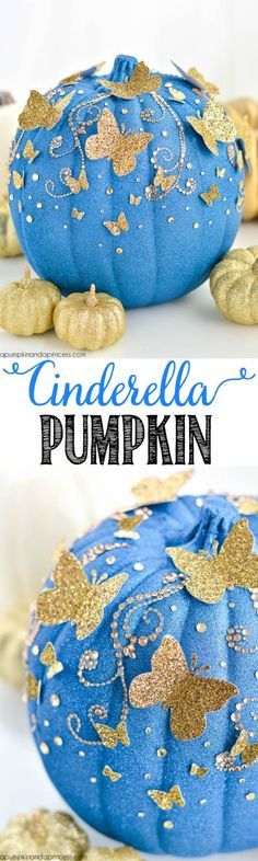 a blue pumpkin covered in gold glitters and sitting on top of a white table