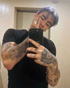 a man taking a selfie in the mirror with his hand on his face and arm