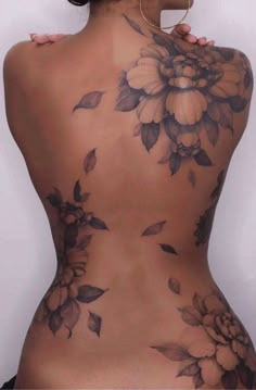 the back of a woman's body with flowers on it