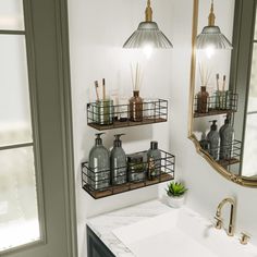 a bathroom sink sitting under two mirrors next to a mirror above a white counter top