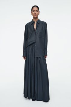 This midnight-navy maxi skirt pays homage to utility with its oversized cargo pocket. It's crafted from a flowy cupro blend with a subtle sheen and designed with a gathered, elasticated waist and an A-line shape that creates a sense of movement. Style it with ballet flats. Regular fit Shell: 67% Cupro, 33% Cotton. Excluding trims / Machine wash Back length of size EU 36 is 99.5cm / Model wears a size EU 36 Belted Cape, Party Mode, Mens Cardigan Sweater, Flowy Design, Denim Sweater, Cargo Pocket, New Arrival Dress, Sweater Blouse, Shibori