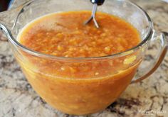 a glass measuring cup filled with food on top of a counter