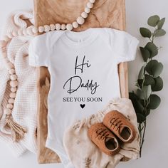 a baby's bodysuit with the words, hey daddy see you soon on it