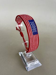 "A patriotic bracelet in the colors of the American flag makes you feel part of the country in which you live and be proud of it. The bracelet is suitable for both young and older people, men and women. This is handmade, made with love for customers. High quality Czech beads are used in this work. Bracelet width 7/8\" x length 7 1/2 - 9\" (adjustable with a slip knot).   PACKAGING: Each of our products is sent in a gift box. We will be grateful for your feedback and new order. We will be glad if you look at other products in our store to have a wider choice. The assortment will be replenished with new products." Adjustable Bracelets For Beach And 4th Of July, Adjustable Beach Bracelets For 4th Of July, Patriotic Adjustable Friendship Bracelets, Adjustable Patriotic Friendship Bracelets, Adjustable Patriotic Friendship Bracelets For 4th Of July, Blue Adjustable Bracelets For 4th Of July, Adjustable Friendship Bracelets For 4th Of July, Casual Multicolor Bracelets For 4th Of July, Patriotic Red Adjustable Beaded Bracelet