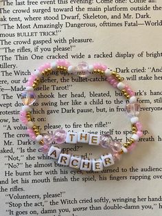 a book page with a bracelet that says, the catcher on it's side