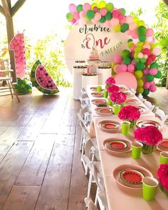 a table set up for a watermelon themed birthday party