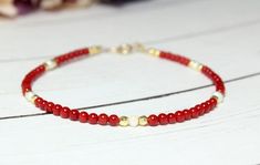 This tiny Coral mix with faced natural gold polished Hematite stone.Simple and timeless. Materials  - 2 mm round Red Coral  - 2-2.5 x 3-3.5 mm natural shape Ivory freshwater pearls  - 2 mm 18K Gold Plated Natural Hematite stones  - 14K gold filled clasp and finding.  Bracelet Length Options: Red Beaded Dainty Jewelry, Minimalist Red Beaded Bracelet With Tiny Beads, Dainty Red Beaded Bracelets With Tiny Beads, Minimalist Red Beaded Bracelets As Gift, Minimalist Red Round Bead Bracelets, Red Minimalist Beaded Bracelet Gift, Red Bracelets With Tiny Beads As Gift, Red Bracelets With Tiny Round Beads, Red Beaded Dainty Bracelets