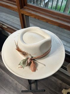 Discover the rugged charm of our Burned Western Hat. This unique, handcrafted cowboy hat features a distressed look, giving it a vintage, well-worn appeal perfect for Western enthusiasts and fashion-forward individuals. Features: Handcrafted Design: Each hat is meticulously burned and distressed to achieve a one-of-a-kind look. Premium Materials: Made from high-quality materials for durability and comfort. Unique Aesthetic: The burned finish adds a distinctive vintage style that sets it apart. B White Brimmed Country Style Felt Hat, Country Style White Fedora Hat, White Country Style Fedora Hat, Rustic Fedora Hat For Kentucky Derby, Rustic Wide Brim Hat For Kentucky Derby, Rustic Flat Brim Fedora For Kentucky Derby, Rustic Adjustable Felt Hat For Kentucky Derby, Western Cream Sun Hat For Rodeo, Western Style Cream Sun Hat For Rodeo