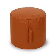 an orange round ottoman sitting on top of a white floor