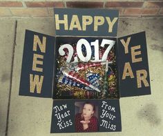 a happy new year sign on the side of a building with pictures and words in it