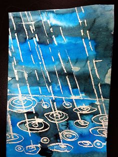 an abstract painting with blue and white colors on black paper, depicting rain falling down