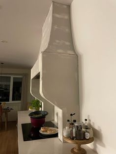 a stove top oven sitting on top of a kitchen counter next to a white wall