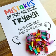 there is a sign that has some colored crayons on it with the words, mistakes are proof to you are trying