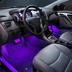 the interior of a car with purple lights