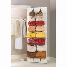 a rack with purses and handbags hanging from it's sides in front of a closet