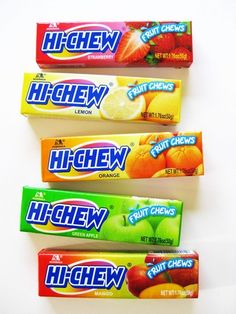 three boxes of high chew fruit chews sitting on top of each other in front of a white background