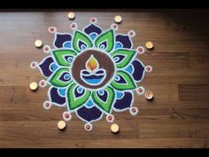 a decorated diya with candles on the floor