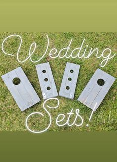 four pieces of wood sitting on top of grass with the words wedding sets written above them