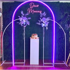 an arch decorated with purple flowers and candles for a wedding or special event ceremony at night