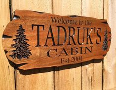 a wooden sign that says welcome to the tadrrus cabin