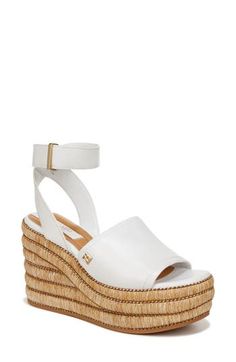 Gorgeous rows of woven raffia dance around the platform wedge of this cabana-ready sandal detailed with luminous hardware. 4 1/4" heel; 2" platform Adjustable ankle strap with hook-and-loop closure Cushioned footbed Leather upper/synthetic lining and sole Imported White Straw Wedge Sandals With Woven Sole, White Synthetic Sandals With Woven Leather, Summer Woven Leather Wedge Sandals, Summer Wedge Sandals With Woven Leather, Spring Woven Leather Wedge Sandals, Spring Synthetic Woven Leather Wedge Sandals, White Straw Wedge Sandals With Open Toe, Woven Raffia, The Platform