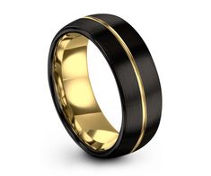 a black and gold wedding ring with an elegant design