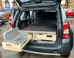 the back end of a car with its cargo compartment open and it's seat folded down