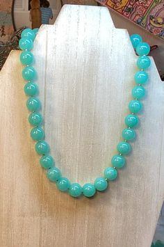 This beautiful Jade round necklace is a must for your jewelry box! It is classy and its color is very unique. The mint round beads are about 10mm or about 1/2 inch in diameter. The length is about 19 1/2 cm in length, or 16" long. The round, polished, smooth round beads, have a nice effect when reflecting the lights. I finished the necklace with a square shape gold plated toggle clasp, that makes it easy to put it on. And take it off as well! I added free earrings to go with it! The listing is f Elegant Jade Necklaces With Round Beads, Elegant Round Jade Beaded Necklaces, Classic Round Beaded Necklaces As Gift, Formal Beaded Necklaces With Large Round Beads, Formal Beaded Necklaces With Large Beads, Classic Round Gemstone Beads Necklaces, Formal Round Beaded Necklace With Large Beads, Formal Round Beaded Necklaces With Large Beads, Classic Round Gemstone Beads Necklace