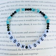 a beaded bracelet with the word dorklove written on it and black beads