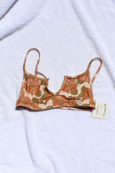 Sporty meets feminine. Features a t-shirt inspired neckline and flattering curved seams underneath the cups. Our Woodstock print is inspired by vintage floral fabric. subtly ribbed fabric sustainably made in California Sizing View our Size Guide Exchanges & Returns View our policy here Vintage Floral Prints, Feminine Features, Vintage Floral Fabric, Cute Bathing Suits, Cute Bikinis, Swimmers, Cheeky Bikinis, Banksy, Dream Clothes