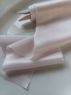 two pieces of pink fabric on a white plate