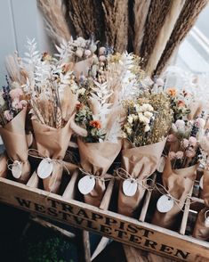 flowers are wrapped in brown paper and tied with twine