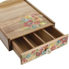 a wooden drawer with flowers painted on the side and drawers open to reveal compartments for pens