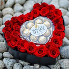 a heart shaped box filled with chocolates and roses